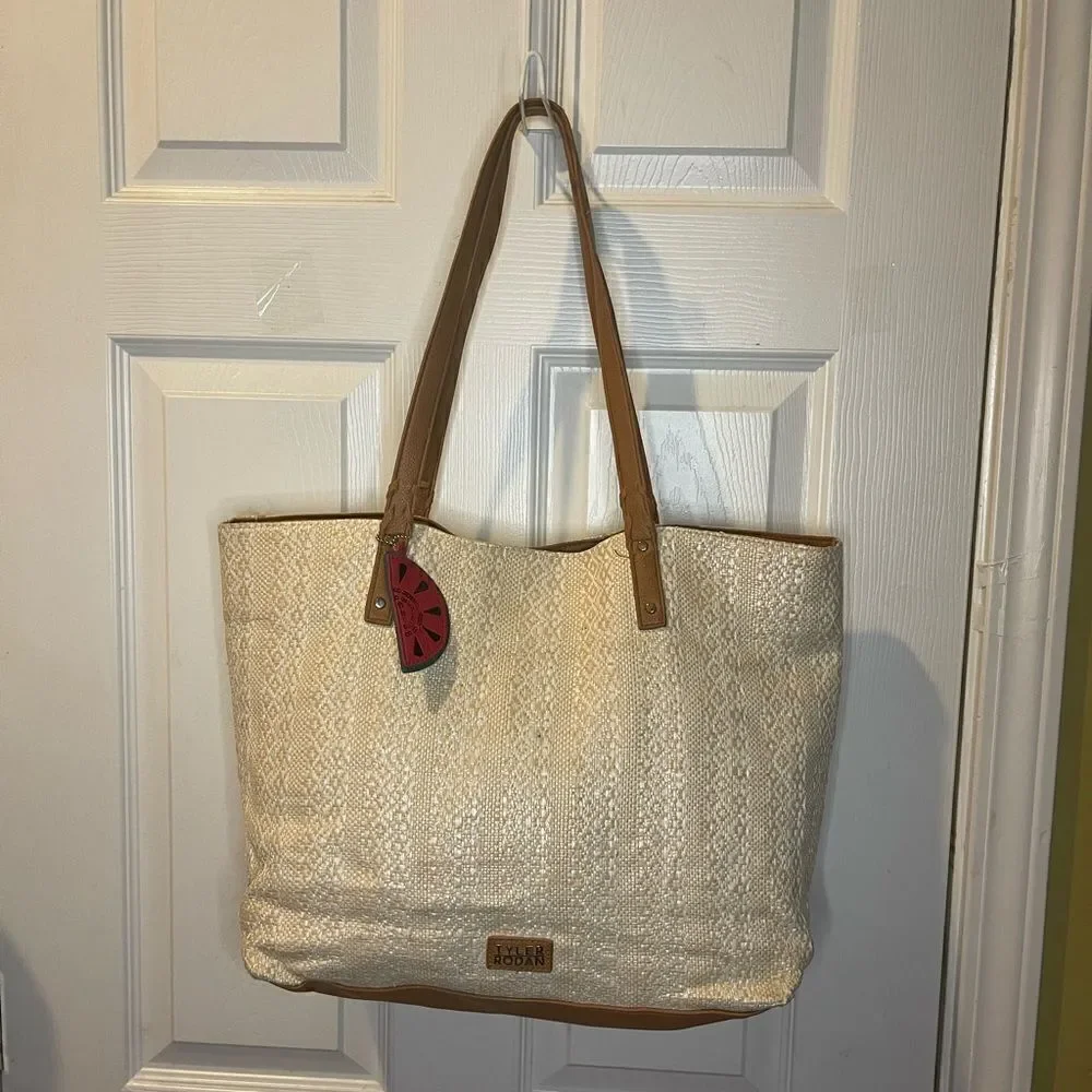Tyler Rodman beige woven large tote with tan faux leather trim and straps .